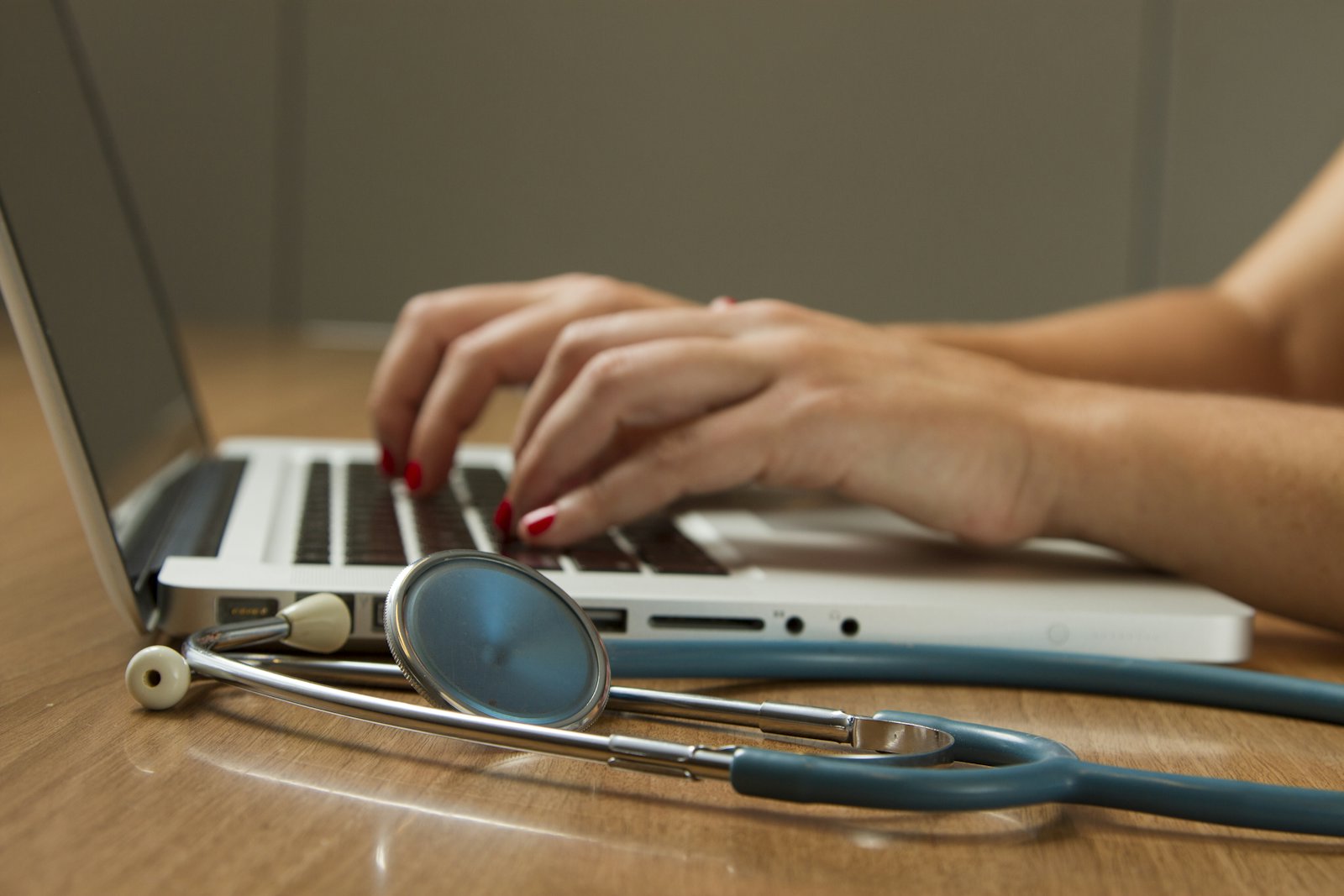 A healthcare professional speaking with a patient in a hospital consultation room